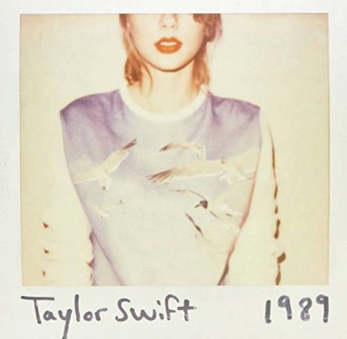Cover artwork of Taylor Swift's album 1989: faded and overexposed polaroid-style photo of a cropped image of Swift in a long-sleeved t-shirt with seagulls on it, with her face cut off at the eyes