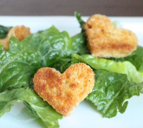 heart shaped crouton on salad greens