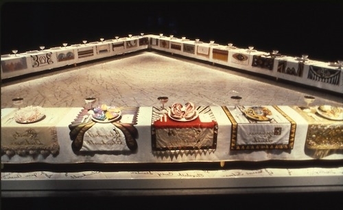 Photo of the physical piece showing 39 elaborate place settings on a large triangular table for 39 mythical and historical famous women