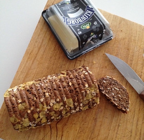 photo of a dense, sliced loaf of rye bread on a cutting board