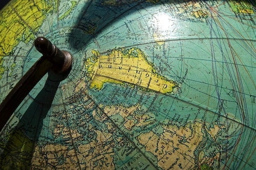 Close-up view of Greenland on a globe, in shades of blue and green