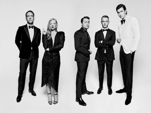 Black and white photo of the cast of Succession facing the camera and posing against a white background