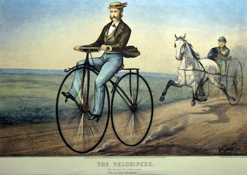 a vintage watercolor illustration titled The Velocipede. It depicts a man in formal attire, including a hat, riding an early bicycle with large front and small rear wheels on a dirt path. In the background, a horse-drawn cart is seen being driven by another man. The artwork has a caption below that reads: The Velocipede. We can beat the fastest steed with our new velocipede.