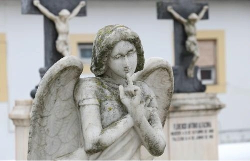 Image via pixabay.com: Angel statue in cemetery holds a finger to her lips, shh!