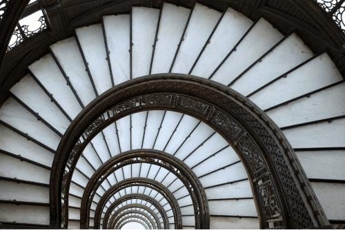 vertigo-inducing view of a spiral staircase from above