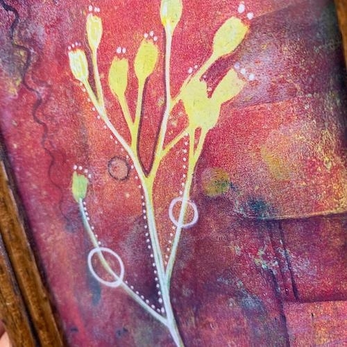 Yellow and white silhouetted flowers with long stems against a highly textured crimson and multicolored background