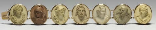 photo of gold bracelet with seven round light colored soft stone raised relief cameos of the Olympic gods