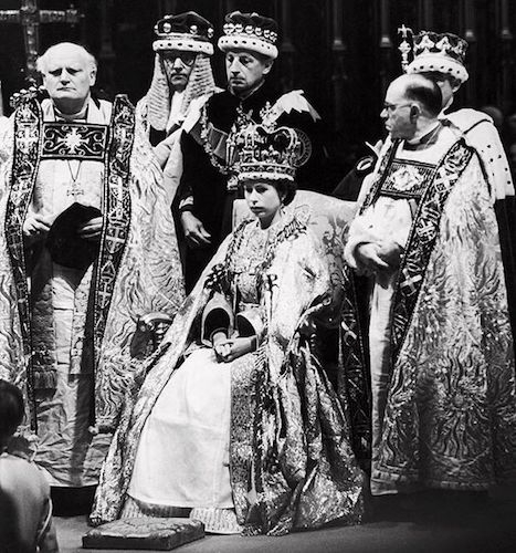Historic photo of the queen seated wearing St Edwards crown with church and state officials around her