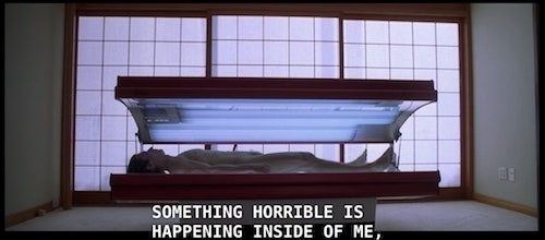 Patrick Bateman NAKED in tanning bed with subtitle SOMETHING HORRIBLE IS HAPPENING INSIDE OF ME
