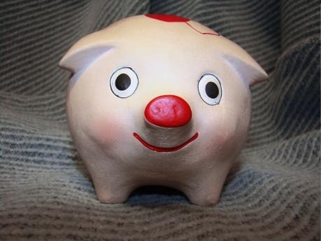 close-up of the face of a cute piggybank pig with a smile and wide eyes